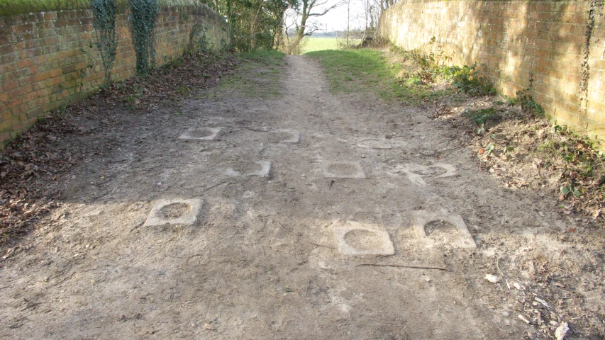 an alleyway with concrete letters carved in the pavement