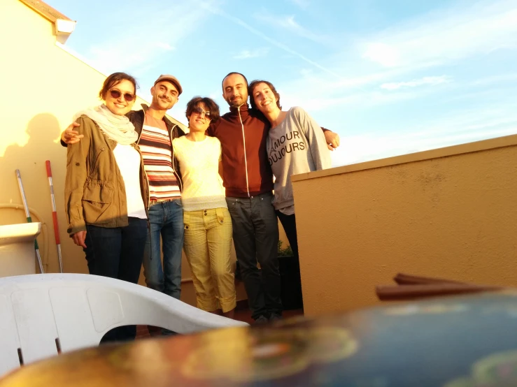 a group of people standing on the roof next to a building