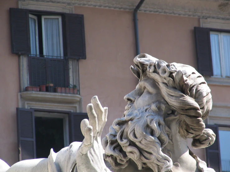 a statue in front of a large building