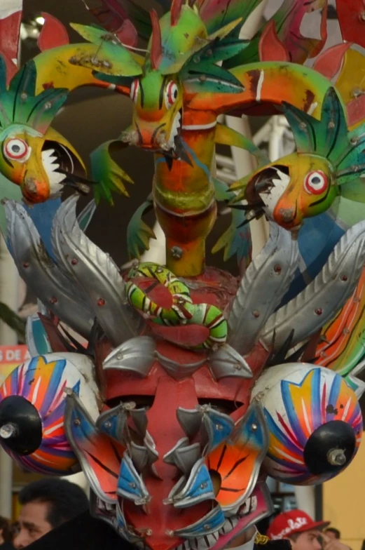 a colorful sculpture of three birds is on display