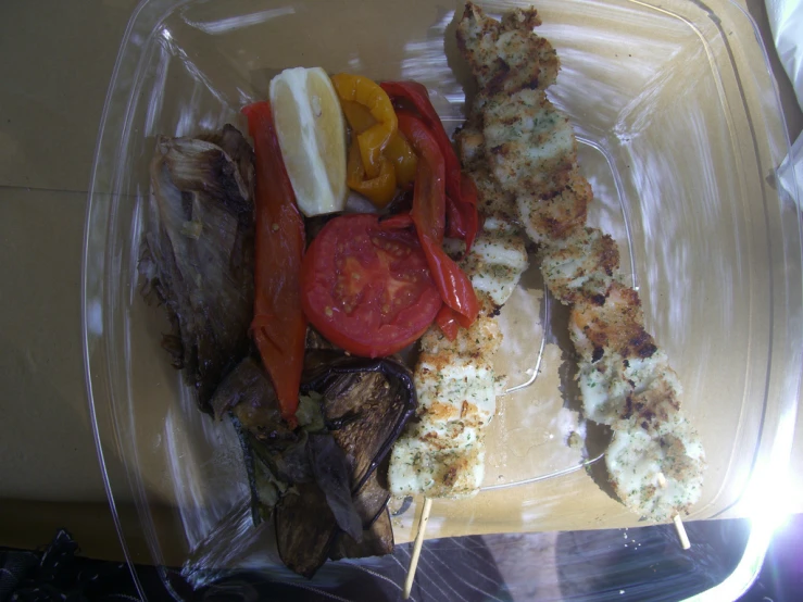 food sits in a clear plastic container on a table