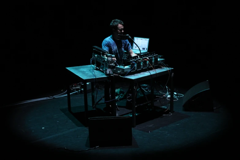 a man sits in front of an electronic keyboard