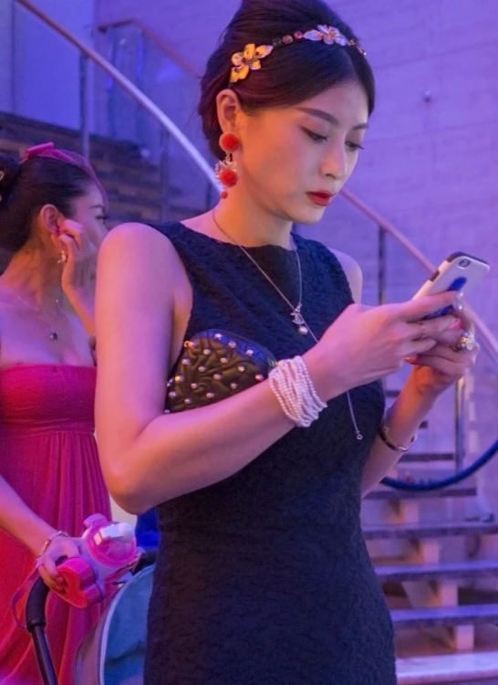 a women who is holding her cell phone in her hands