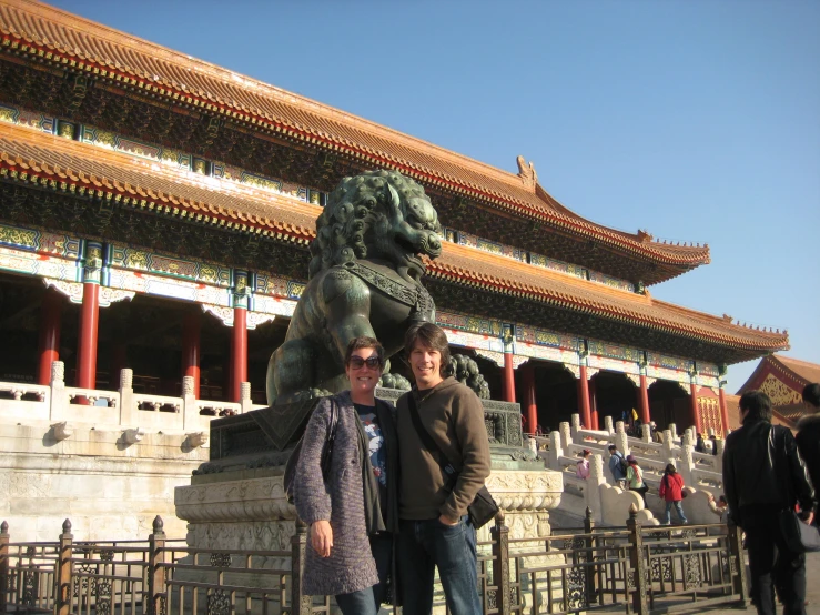 two people standing in front of an ornately designed building