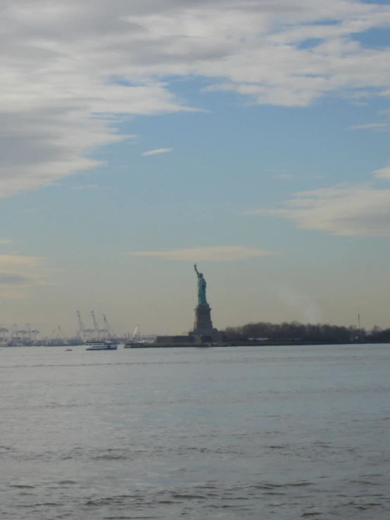 the statue of liberty is surrounded by cranes