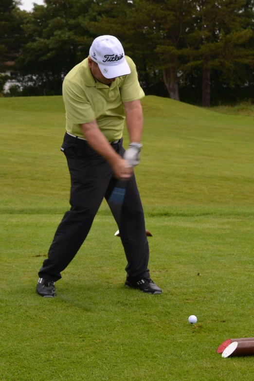 a man swinging a bat at a golf ball