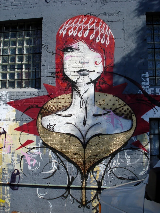 a graffitti portrait of a woman's head wearing a red hairpiece