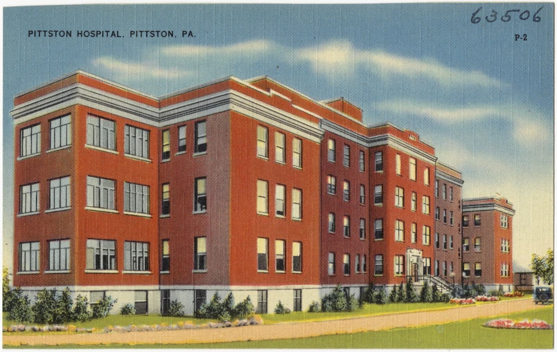 a large brick apartment building sitting in the center of a parking lot