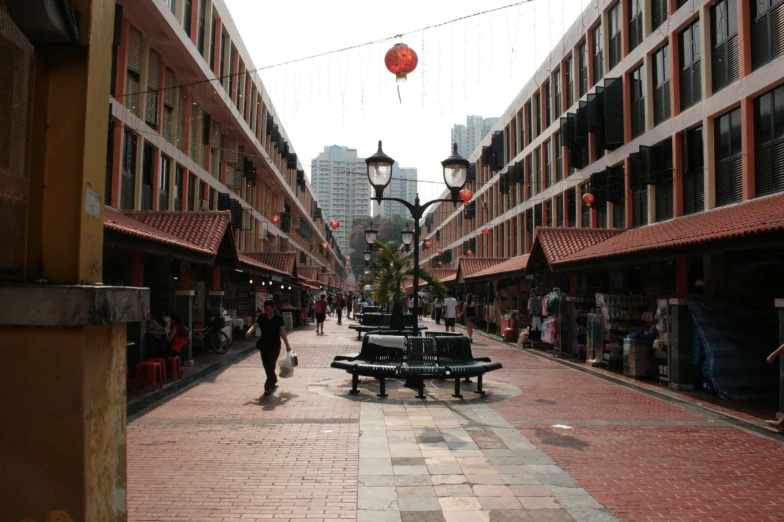 people walk along the streets as people sit outside