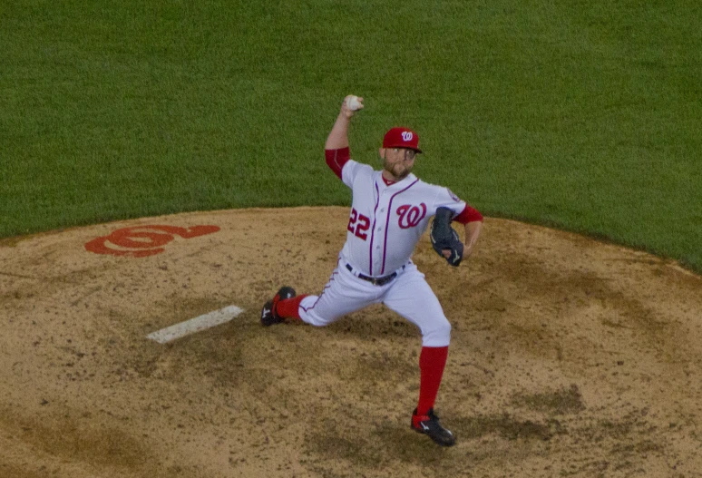 pitcher winding up to throw pitch during baseball game