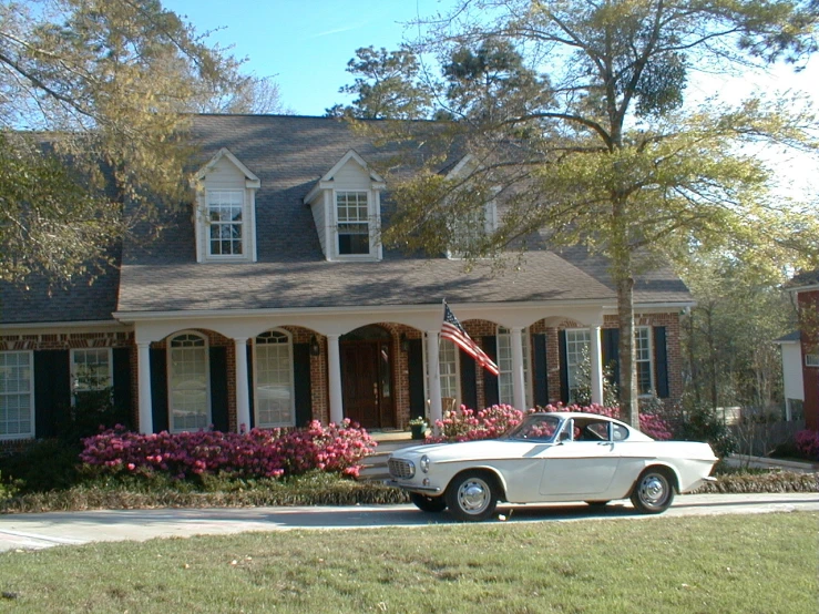 a white car parked in front of a home