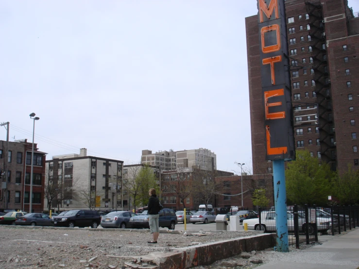 an orange sign that is on the side of a building