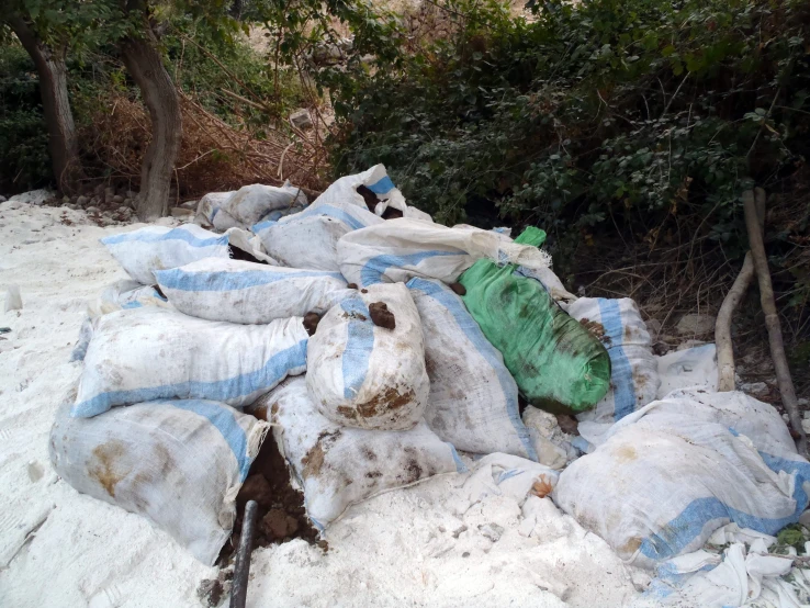 bags of sand that are piled up in the snow