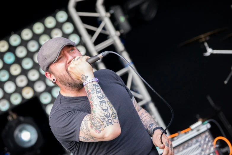 a man singing into a microphone on stage