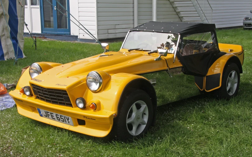 the small sports car is yellow and black in color