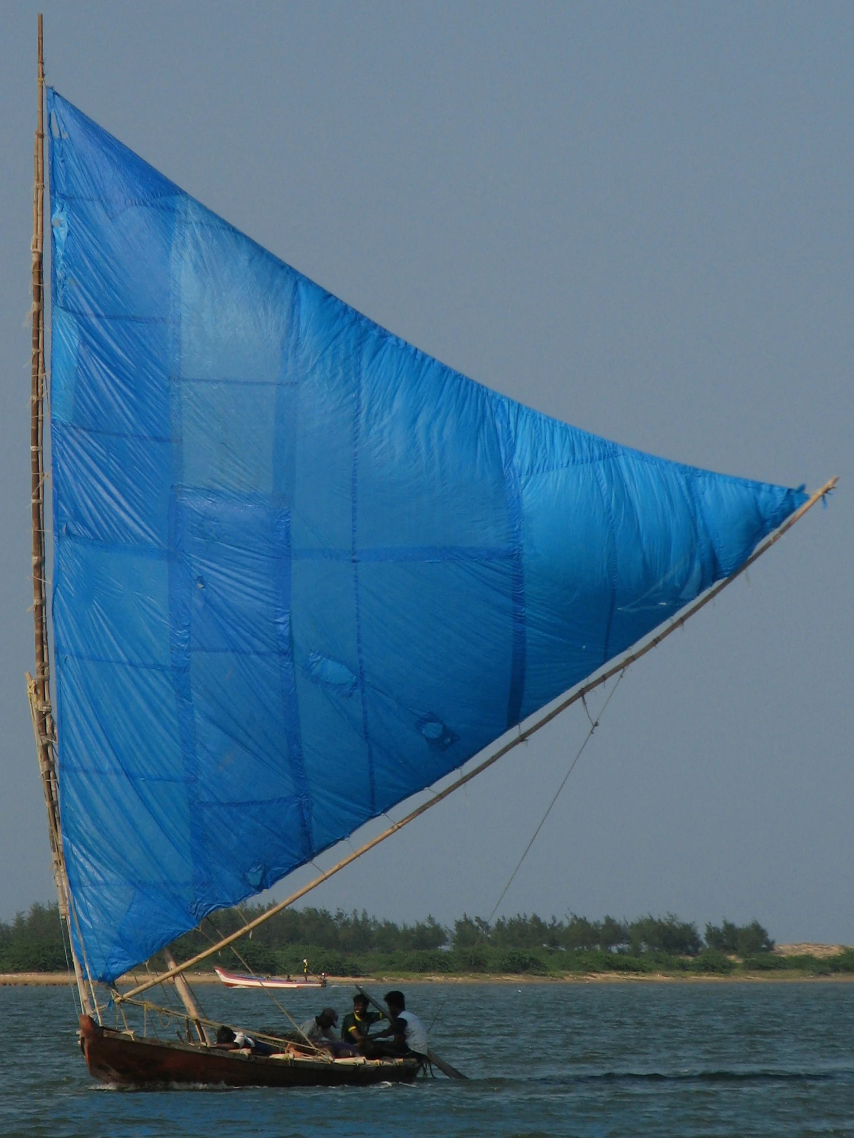 two men in a small boat are sailing