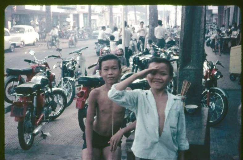 two boys that are standing in the street