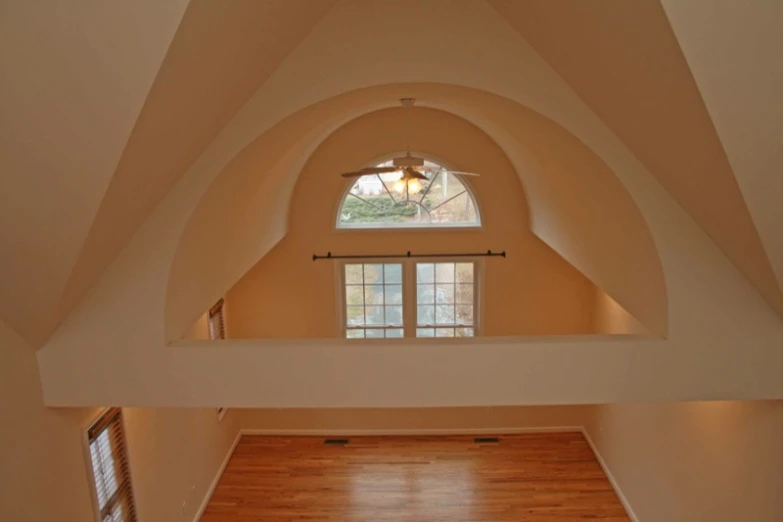 a room with some wood floors and windows