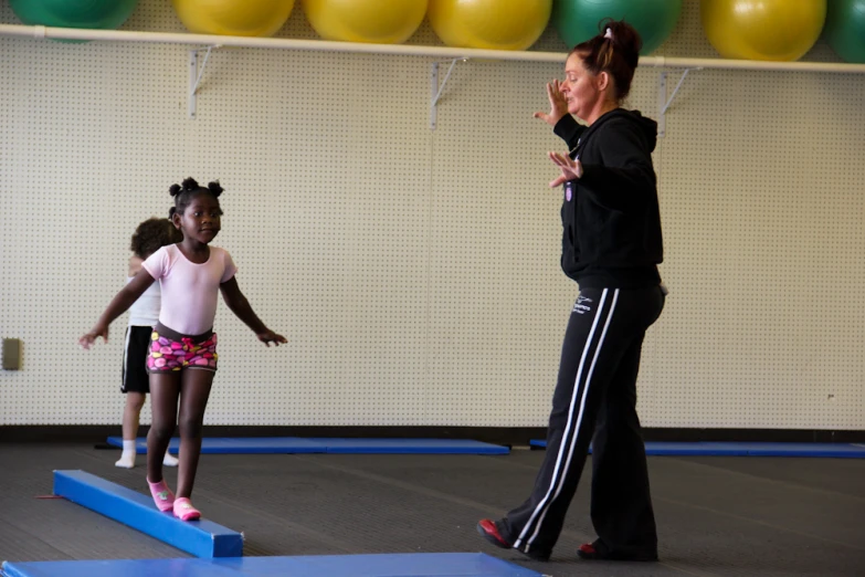 two girls are practicing with their mother