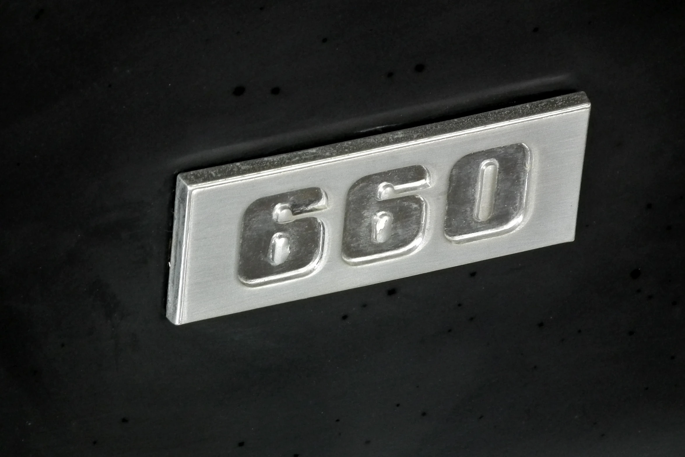 a close up of a plate on a vehicle's side