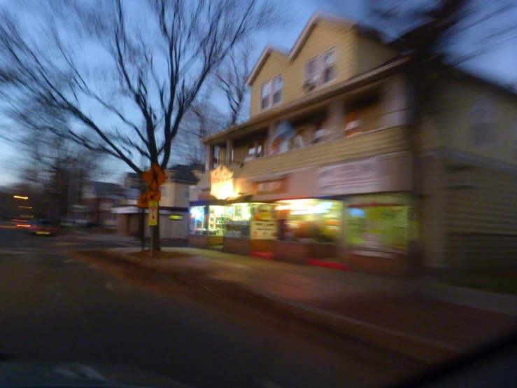 a blurred view of a street corner at dusk