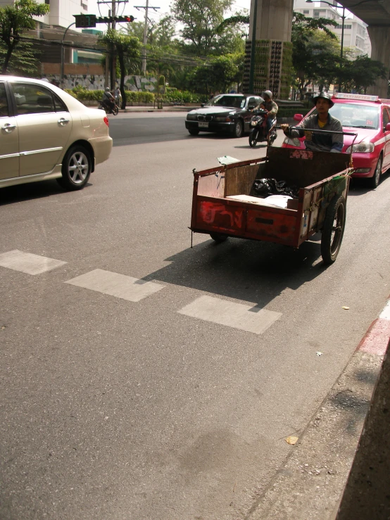 the man is riding in a cart through the streets