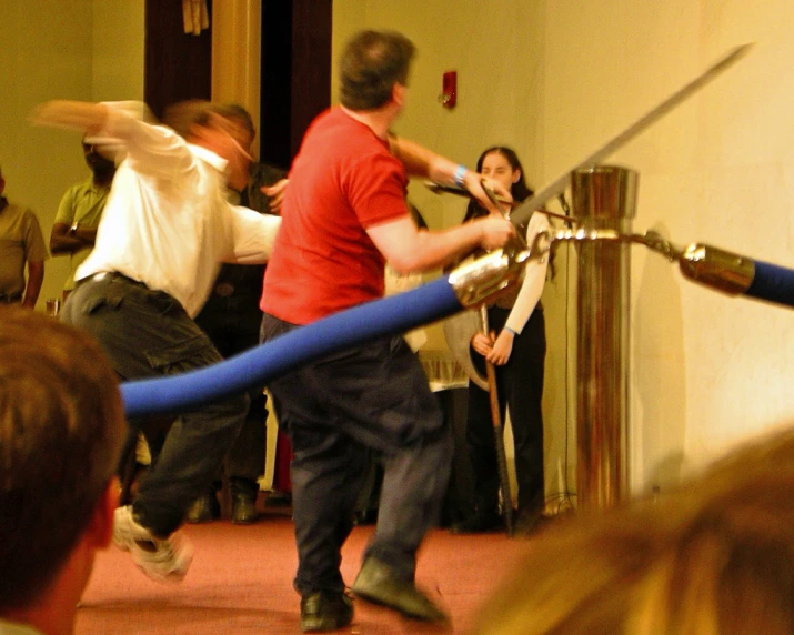 a man is holding a giant sword on the street