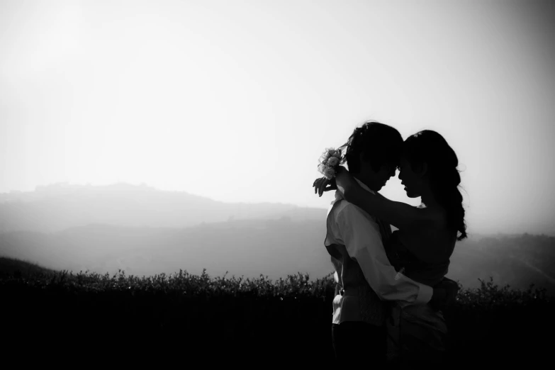 a man hugging a woman who is wearing a flower in her hair