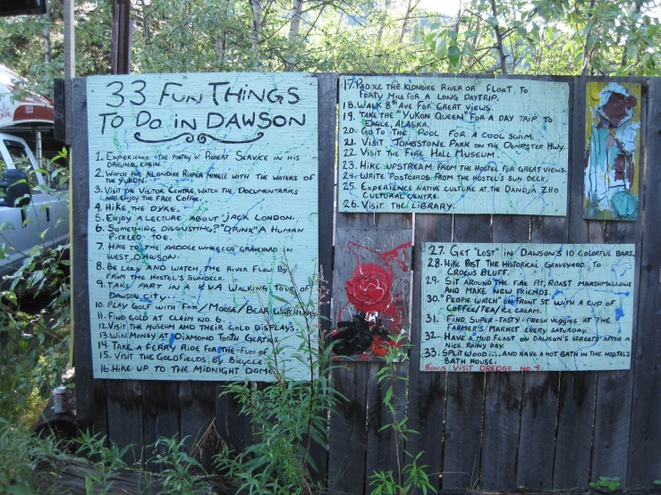 a sign at a park that has been covered in writing