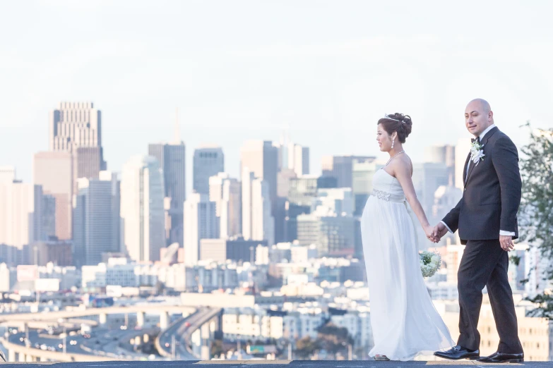 a man and woman holding hands as they stand near each other