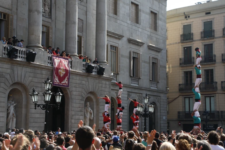 a big group of people watching the people do an aerial trick