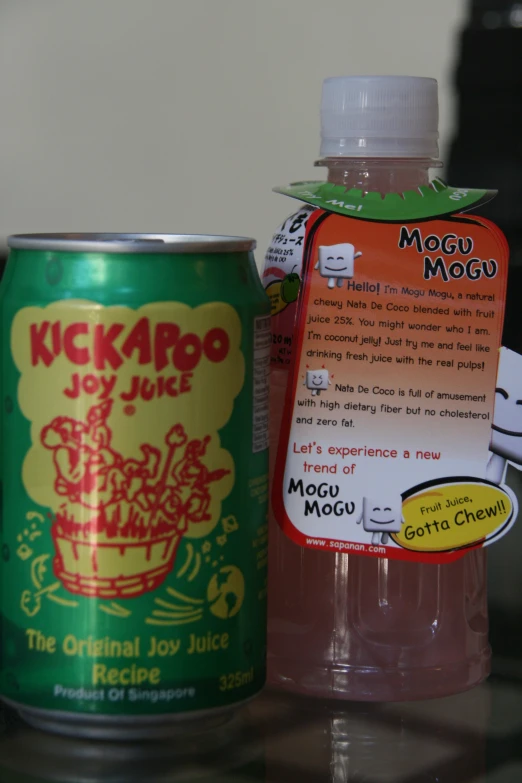 a can of soda next to a can with the tag
