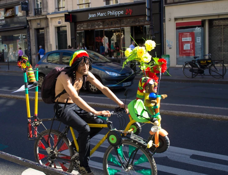 a man wearing a clown hat riding a bike