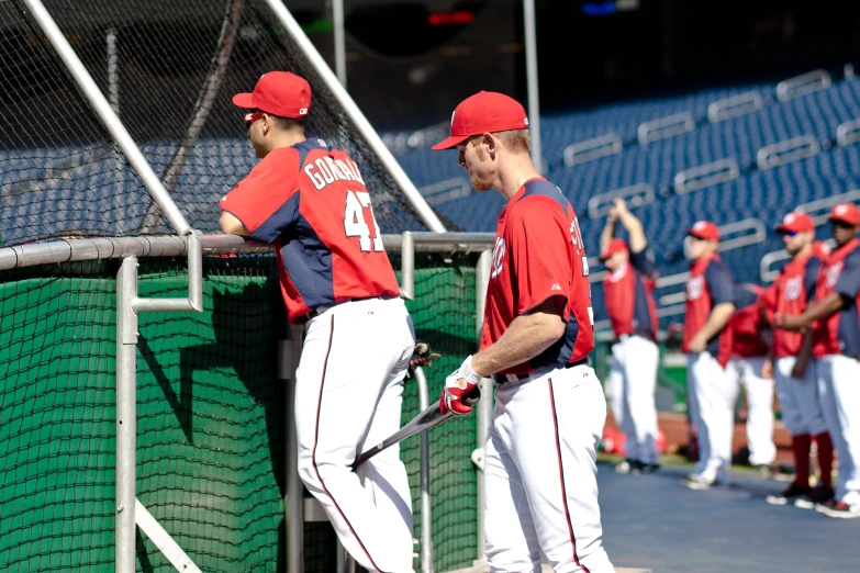 a couple of baseball players in the dugout