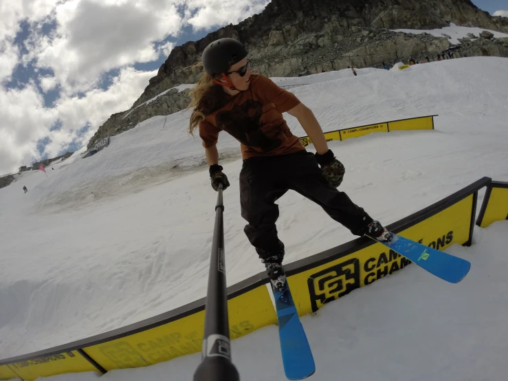 a man riding skis on top of a rail in the snow