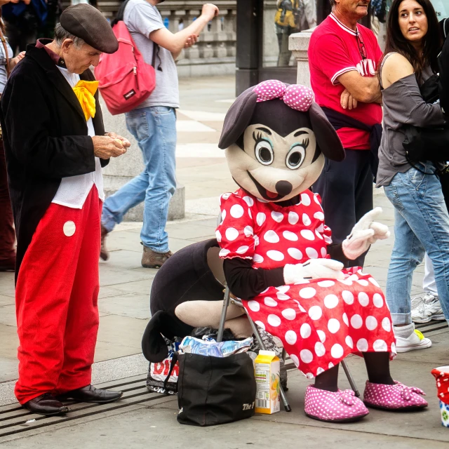 an image of minnie mouse mascot in a red and white dress