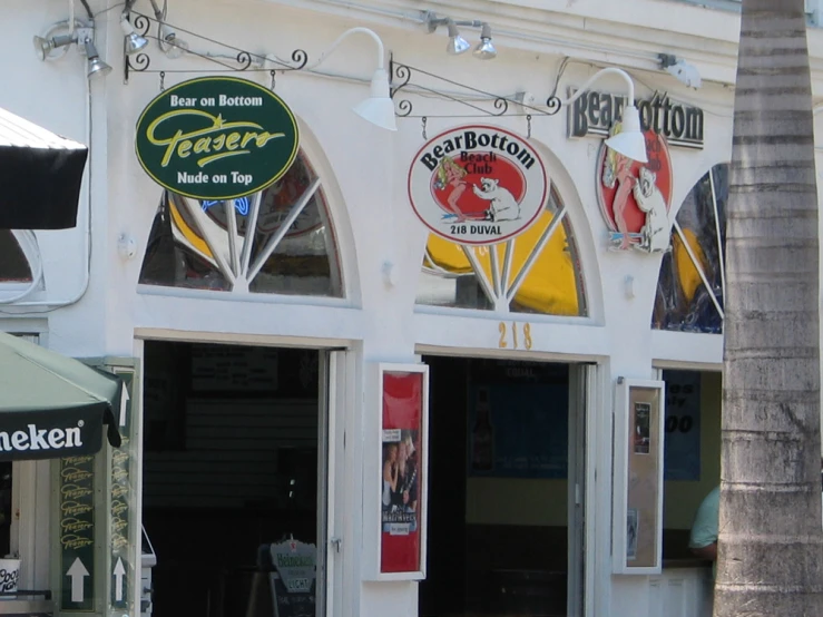 several store fronts are covered in signs and lighting