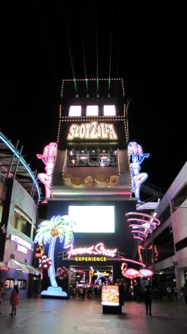 a night time image of the lights of a store and its signage