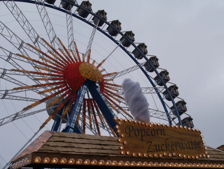 a ferris wheel and sign that reads popcorn garden