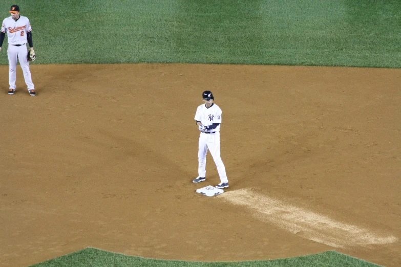 two baseball players one is in white uniform and the other is blue and white