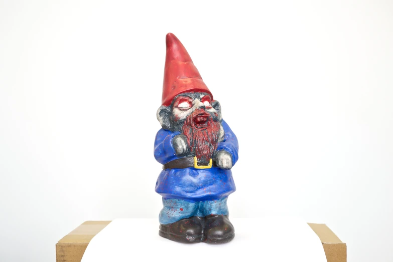 a gnome figurine on a pedestal stands upright