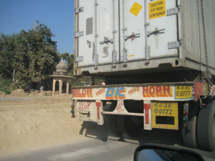 a white truck with various foreign signs on it