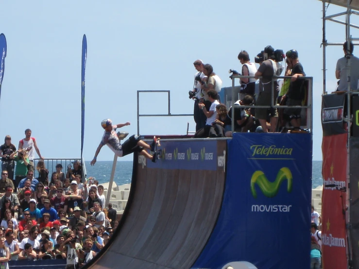 a group of people watching a person skating