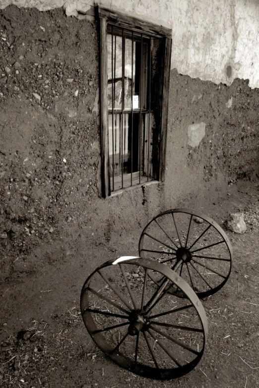 two wheels sitting near an open window in a building