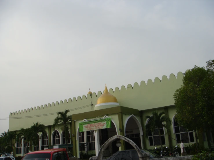 a church with green roof and a large yellow dome