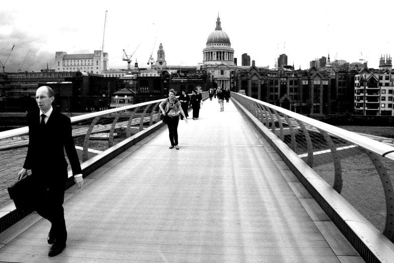 the men are walking over the bridge together