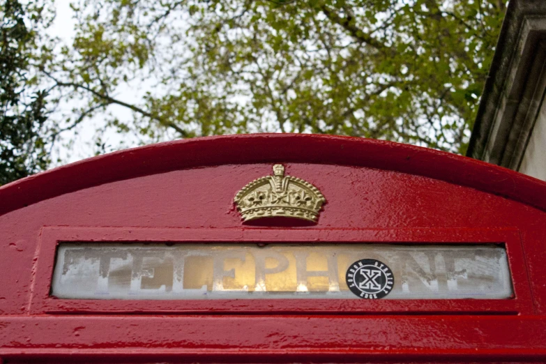 a post box with a plaque on it, the name is engraved and gold