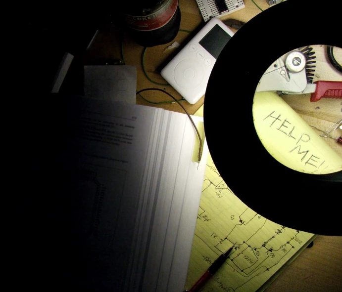 a desk with a circular sign that says hell me