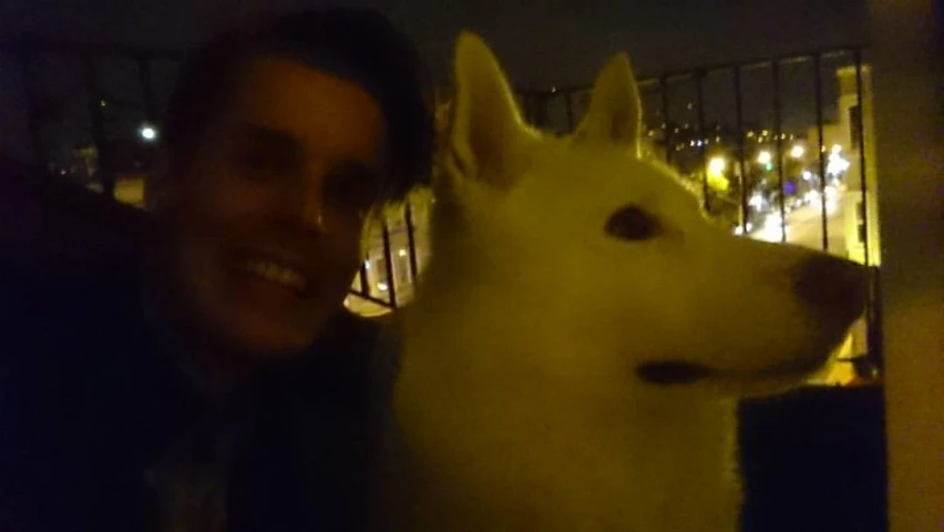 man and dog at night smiling for camera