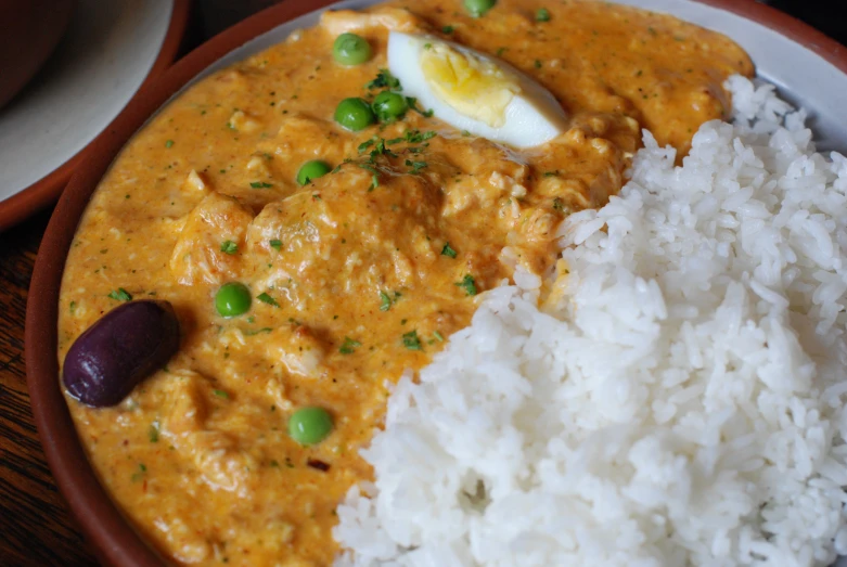 a wooden table topped with rice and meat